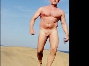 muscle hairy stud showing off on beach