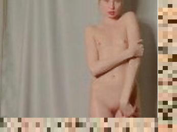 Blonde with small breasts dancing naked in front of the camera.
