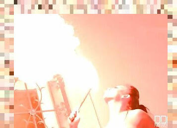 Topless big tits girl plays with fire