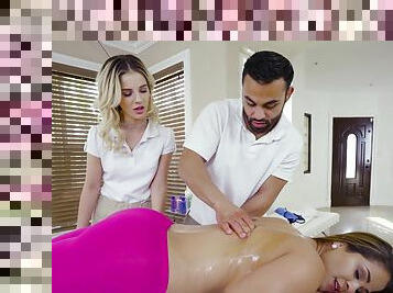 Masseur tries younger slut on the massage table along side his colleague