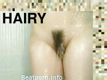 Hairy Asian in bathroom shaves during showering