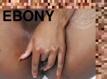 Ebony woman creams on a dildo