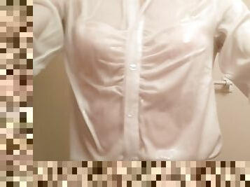 Taking a shower while crossdressing. (pink bra is seen through the blouse)