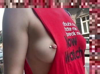 Braless walk in city. Flashing piercing nipples in public.