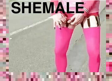 Sissy in pink outfit at the side of the road shows her ass and clit