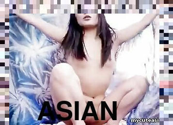 Asian slut is on the beach posing naked