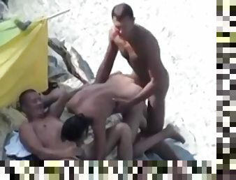 Couple of sluts on the beach caught having a threesome on hidden voyeur cam