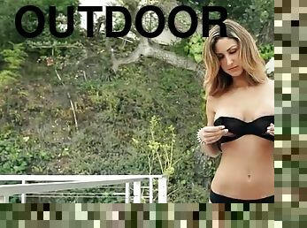 Girl models big tits and tight legs outdoors