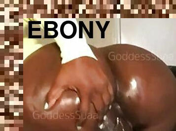 Oiled up ebony rides dildo