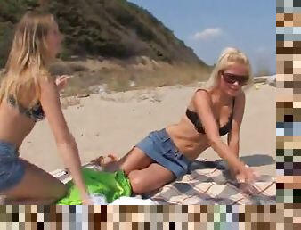 Two blonde lesbians play with their pussies on the beach