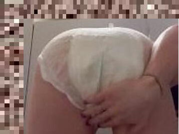 Public diaper girl wets diaper at the gym