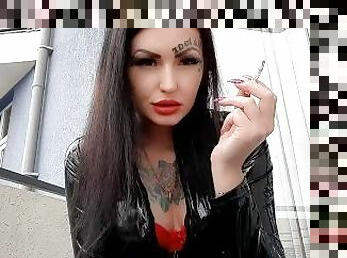 Cigarette smoke. Smoking fetish. Dominatrix Nika smokes 2 cigarettes on the balcony.