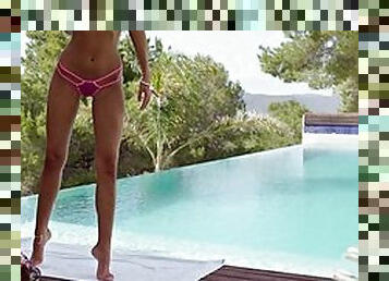 Slim babe has solo fun by the pool