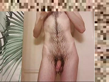 Tall skinny guy taking a hot shower