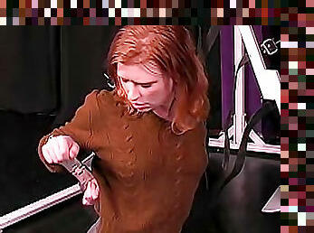 Redhead in sweater bound in dungeon