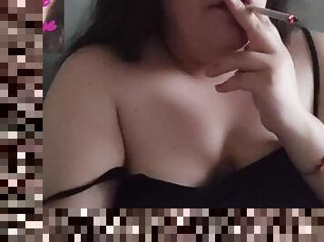 Chubby brunette smoking at home