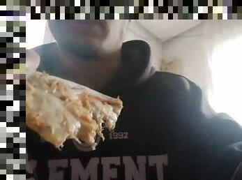 Boy eats a pizza for lunch