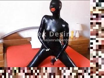 Rubber doll rides a glas dildo