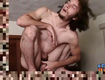 Skinny thug with long hair vigorously tugs on his hard cock